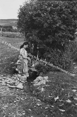 WOMAN WITH CHILD AT STREAM